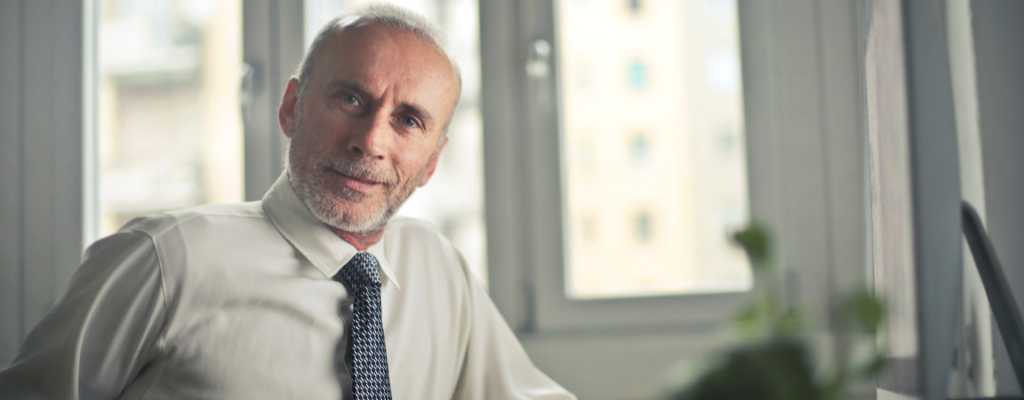 Independent Contractor | Confident Looking Older Man in a white shirt and tie
